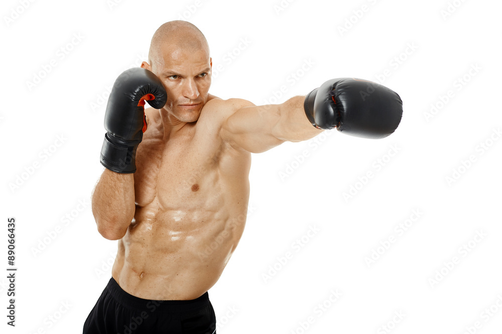 Very fit kickboxer punching on white