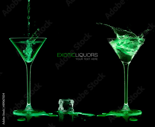 Fototapeta Two Cocktail Glasses with Green Liquor. Style and Celebration Co