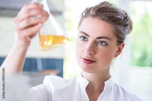 Female chemist holding flask