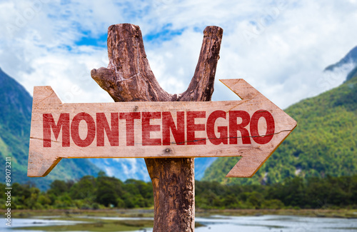 Montenegro wooden sign with mountains background photo