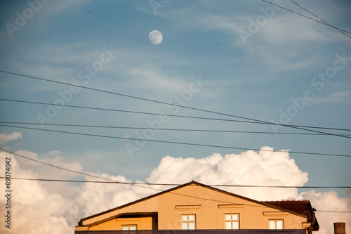 House and blue sky with moon