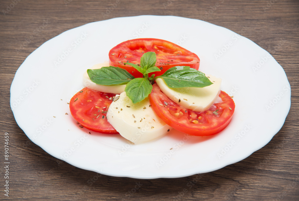 Caprese salad with mozarella cheese, tomatoes and basil Caprese salad with mozarella cheese, tomatoes and basil