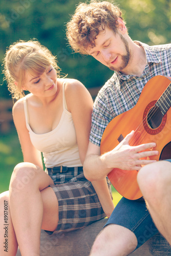 Young couple camping playing guitar outdoor © anetlanda