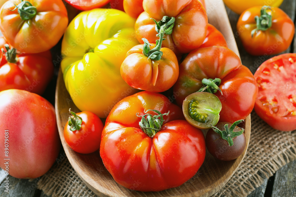 assorted tomatoes on wooden surface assorted tomatoes on wooden surface
