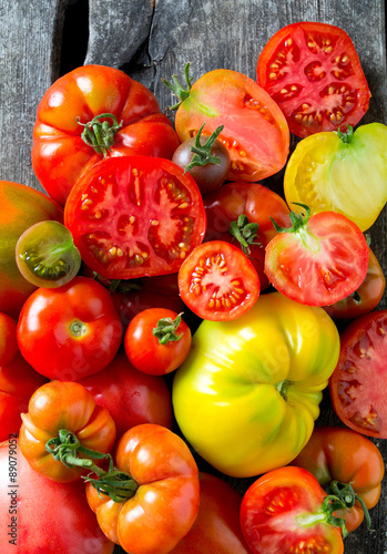 assorted tomatoes on wooden surface