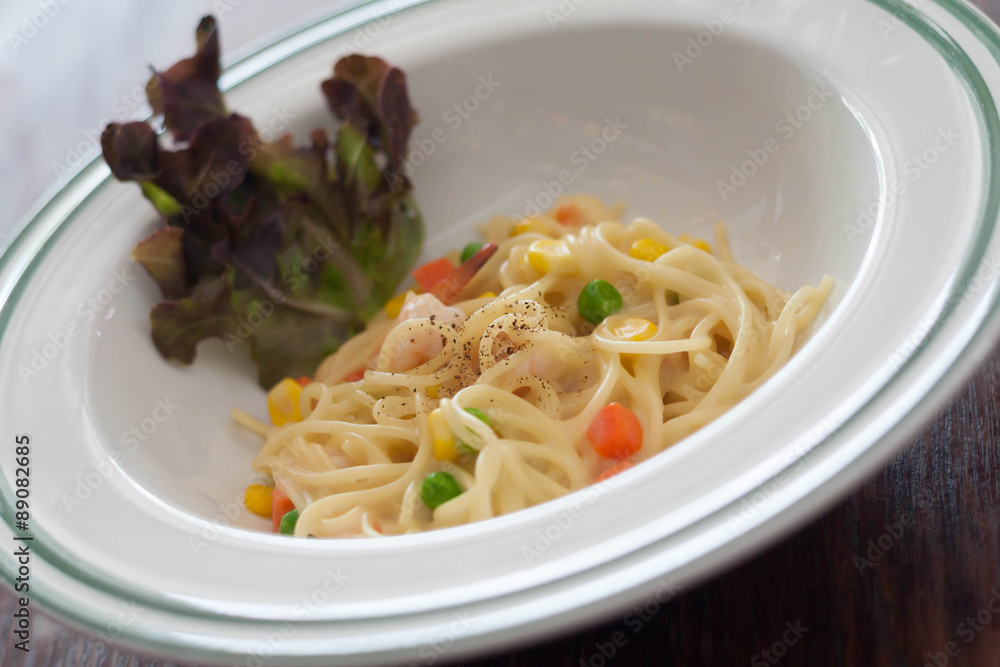 Dish of spaghetti carbonara with carrots, corn, peas, shrimp. Dish of spaghetti carbonara with carrots, corn, peas, shrimp.