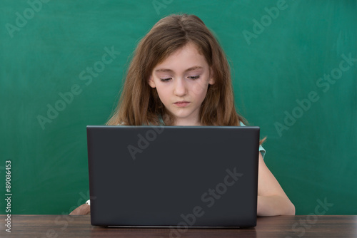 Girl Using Laptop At Desk