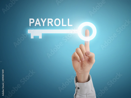 male hand pressing payroll key button