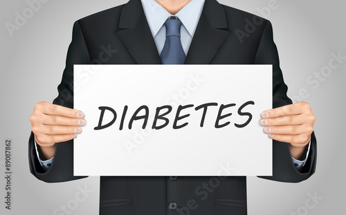 businessman holding diabetes word poster