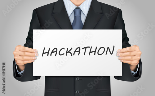 businessman holding hackathon word poster