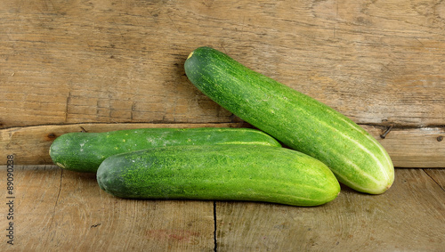 Fresh cucumber on the wooden background