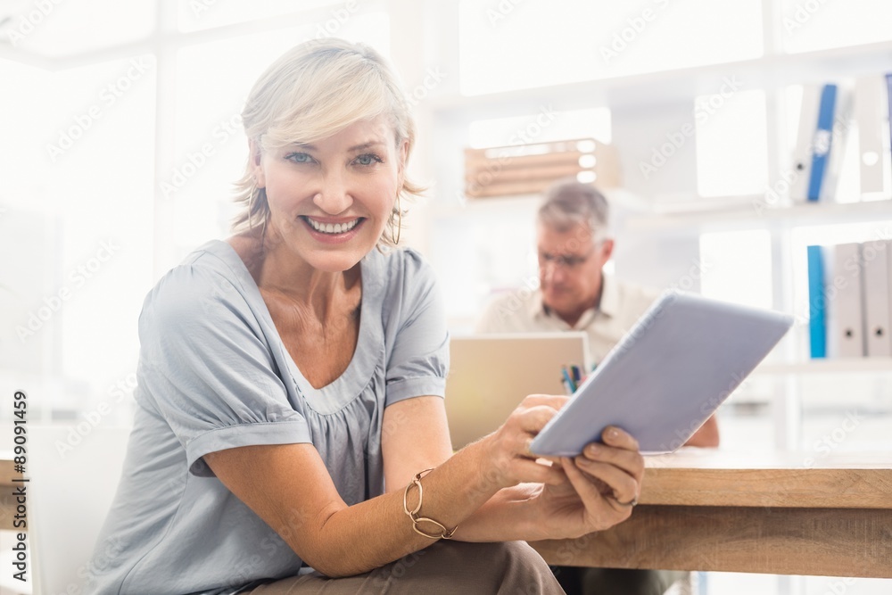 Smiling businesswoman scrolling on a tablet Smiling businesswoman scrolling on a tablet