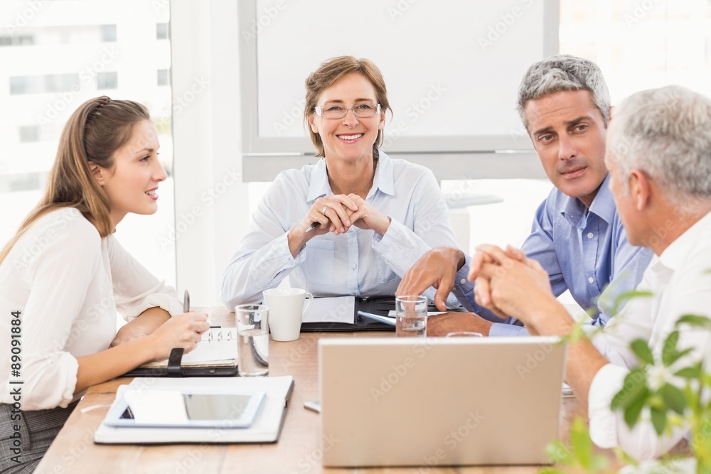 Smiling businesswoman with glasses in a meeting Smiling businesswoman with glasses in a meeting