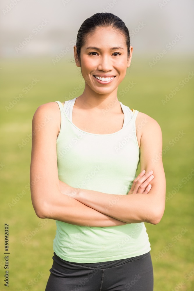 Smiling sporty woman with arms crossed Smiling sporty woman with arms crossed