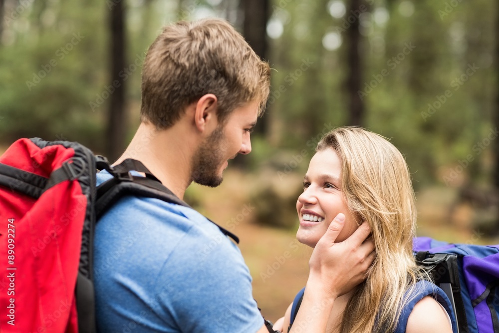 Young happy hiker couple looking at each other