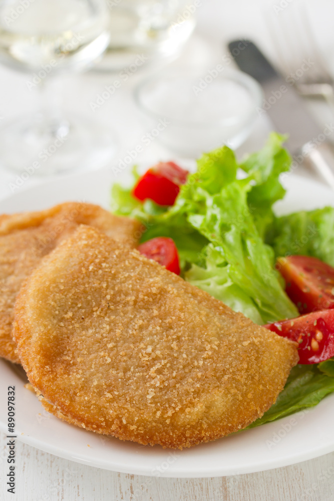 portuguese meat cookies with fresh salad on white dish on white background portuguese meat cookies with fresh salad on white dish on white background
