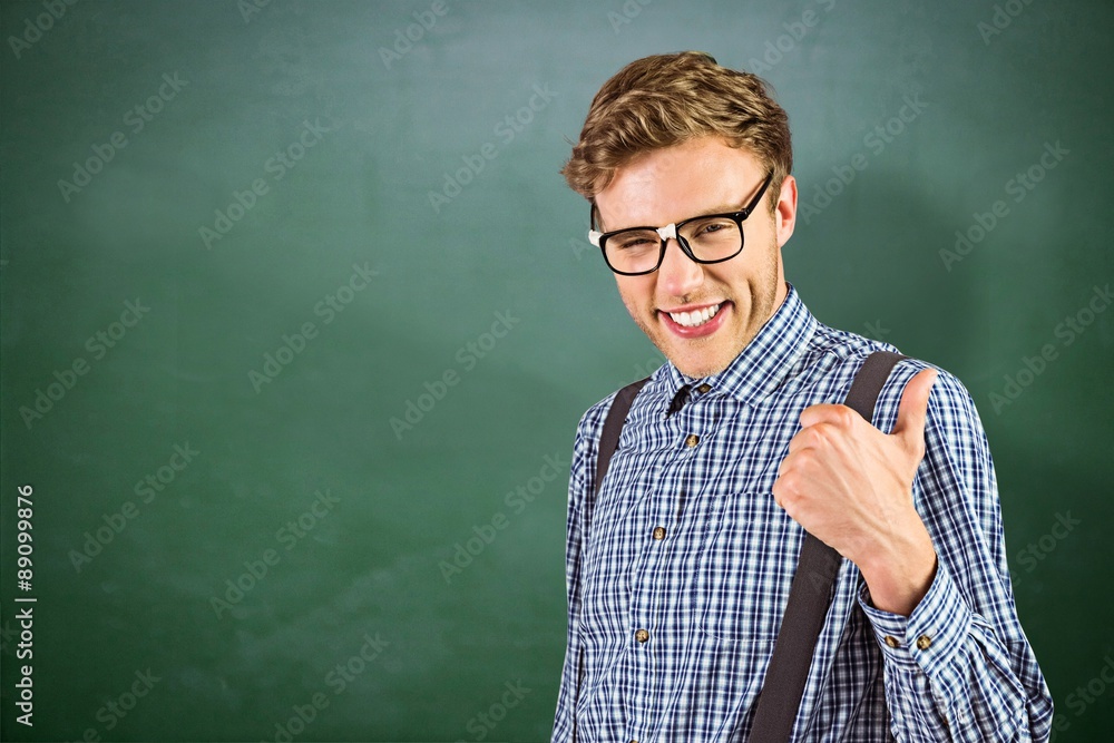 Composite image of geeky hipster showing thumbs up