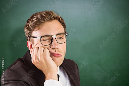 Картината върху платно Composite image of young geeky businessman looking bored