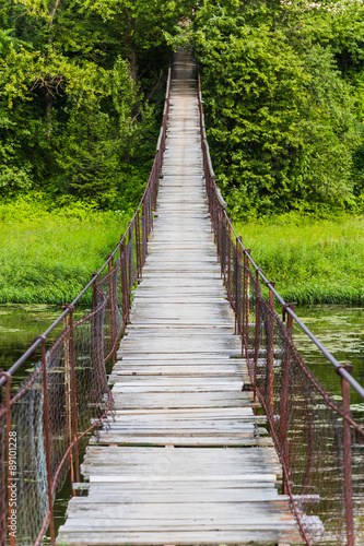 Hanging bridge. Bridge goes over river