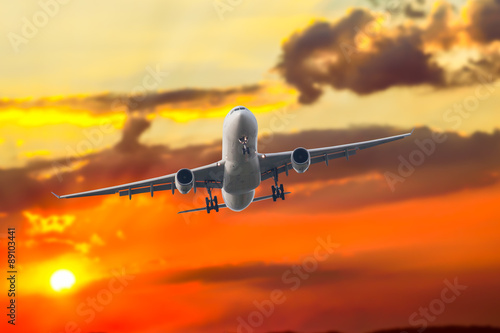 Passenger business airplane take off and flying in sky sunset, u