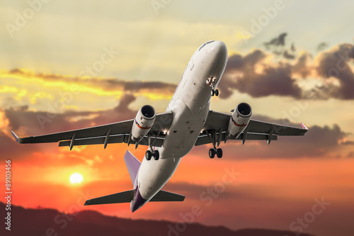 Passenger business airplane take off and flying on sky sunset, u