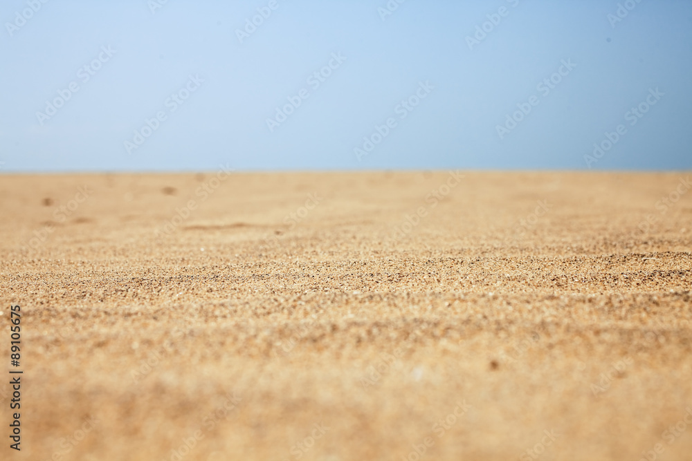 Dry beach sand and clear blue sky