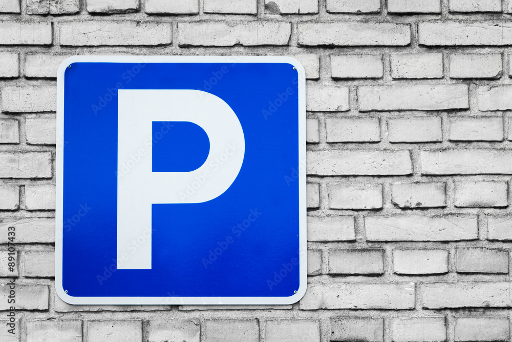 Blue parking sign on black and white bricks Blue parking sign on black and white bricks