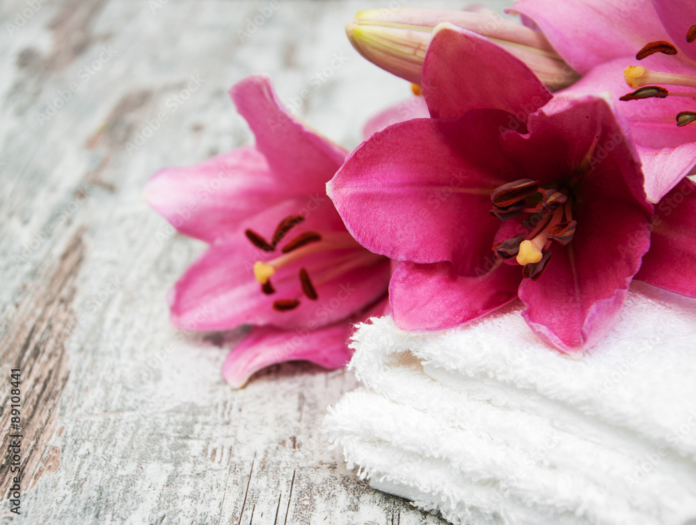 Pink lily and  towels