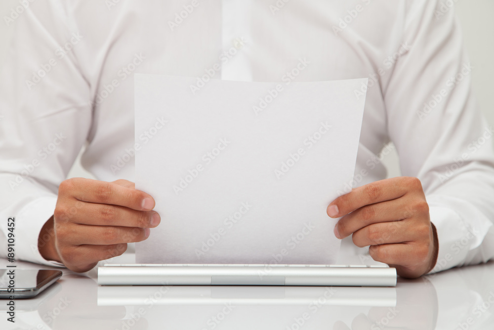 man holds blank sheet of paper in hands man holds blank sheet of paper in hands
