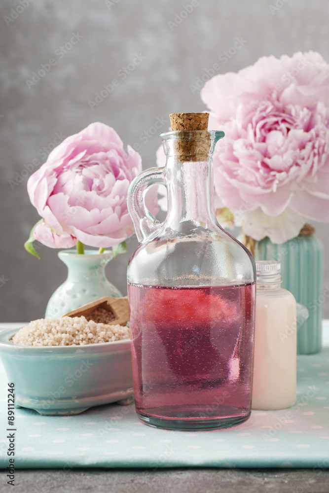 Glass bottle of liquid soap and peonies Glass bottle of liquid soap and peonies