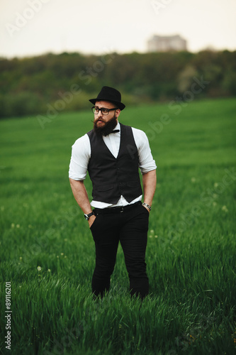 man with a beard, thinking in the field