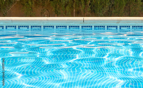 Fotografija Picture of water at the surface of a swimming pool including tiled side and pool edge