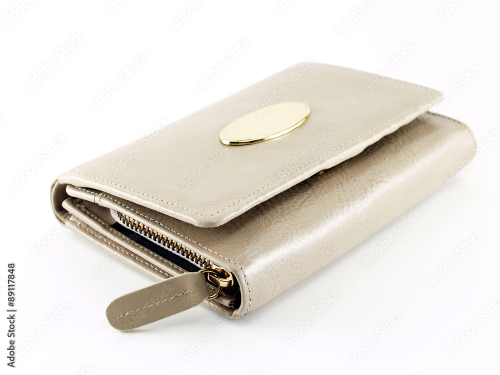 closed beige leather female wallet with blank metallic gold brand emblem isolated on white closed beige leather female wallet with blank metallic gold brand emblem isolated on white