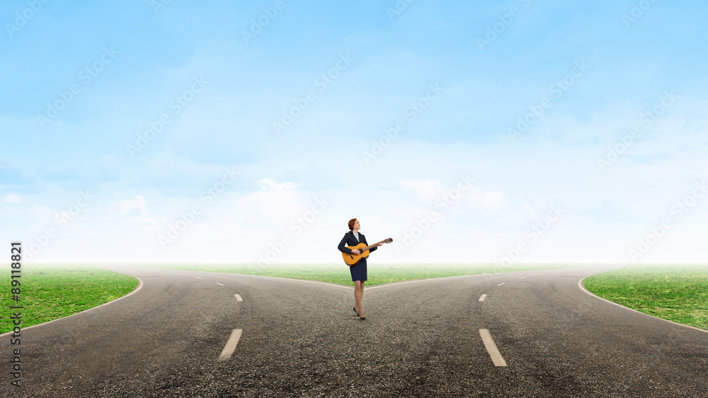 Businesswoman playing acoustic guitar