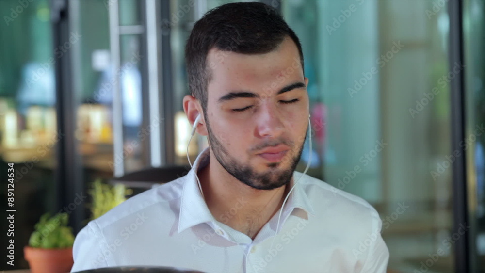Close up o a young man enjoying music Close up o a young man enjoying music