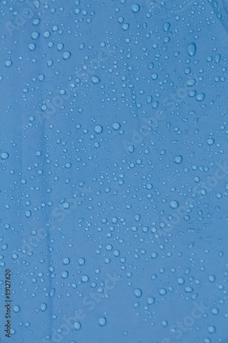 Rain Water droplets on blue waterproof fabric