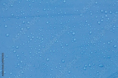 Rain Water droplets on blue waterproof fabric