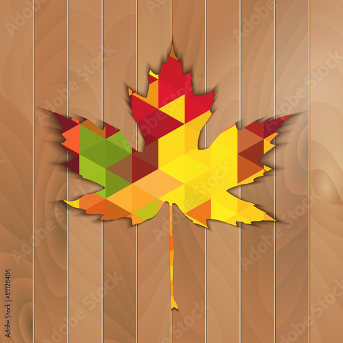 Autumnal Maple Leaf triangle on a wooden background