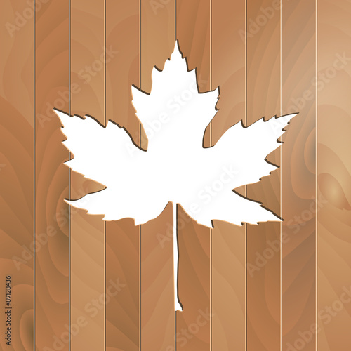 Autumnal Maple Leaf silhouette on a wooden background