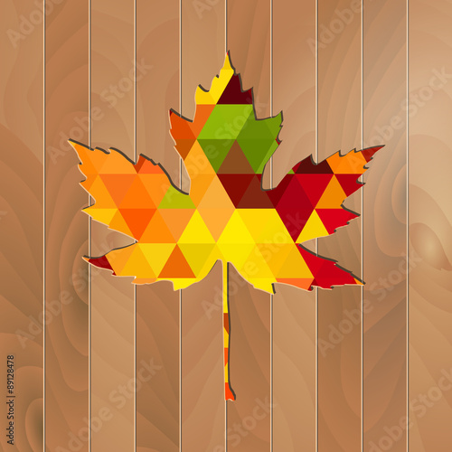 Autumnal Maple Leaf triangle on a wooden background