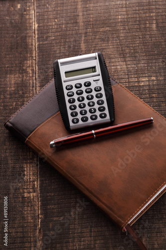 The notebook, calculator and pen