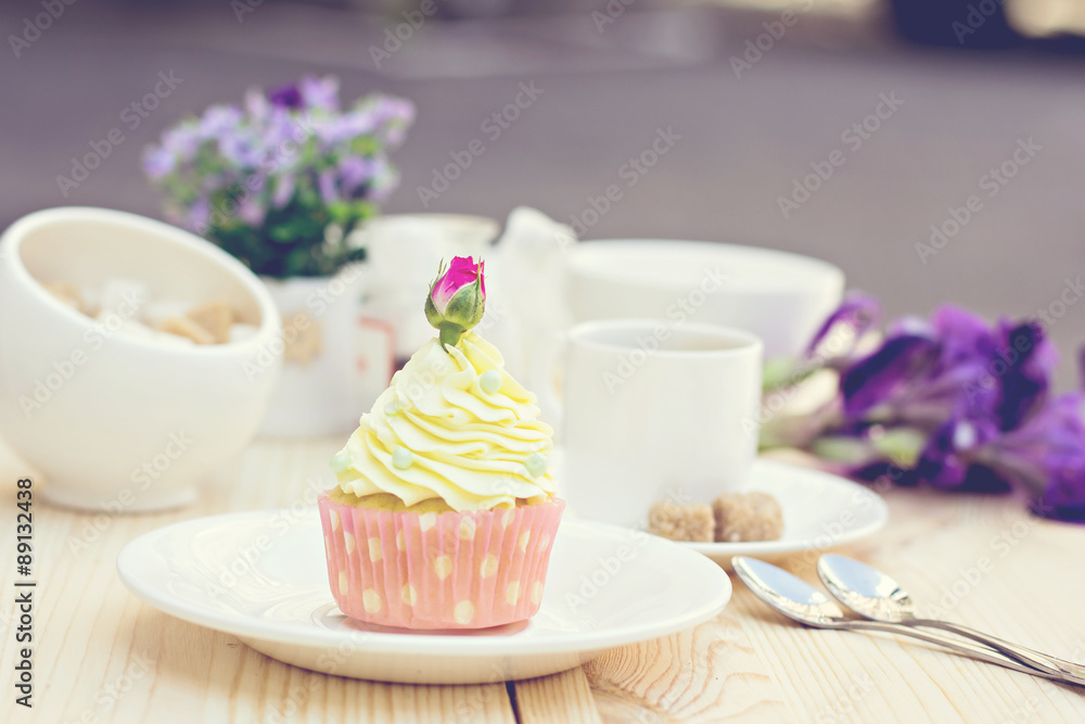 Light yellow Cupcake with rose on the table Light yellow Cupcake with rose on the table