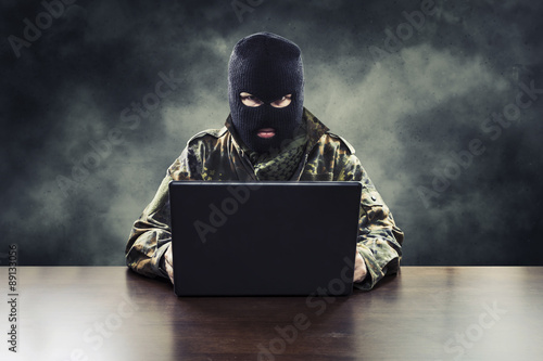 Tableau sur toile Masked cyber terrorist in military uniform hacking army intelligence