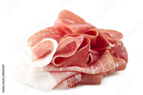 Italian prosciutto crudo ,raw ham leg sliced on white