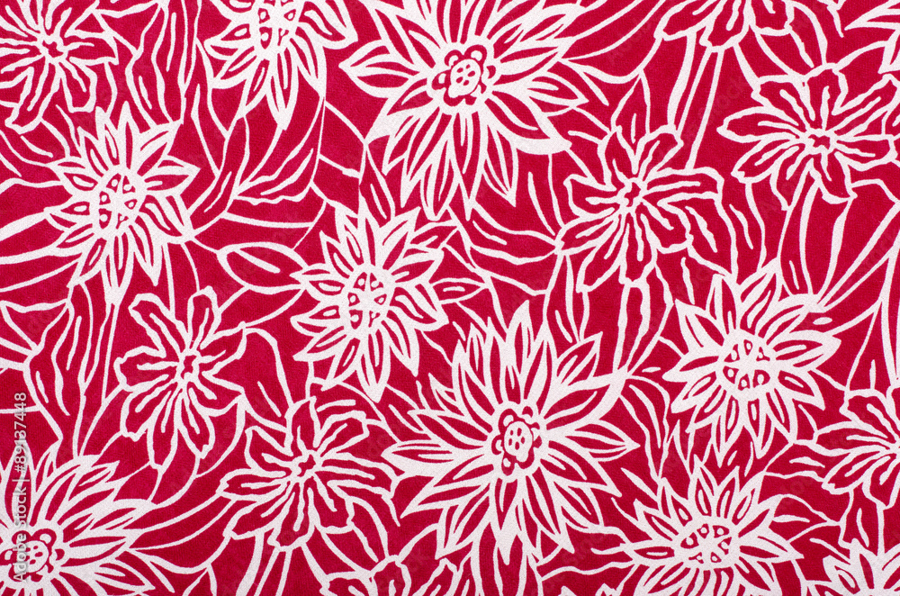 White floral pattern on red fabric. Graphic red flowers print as background.