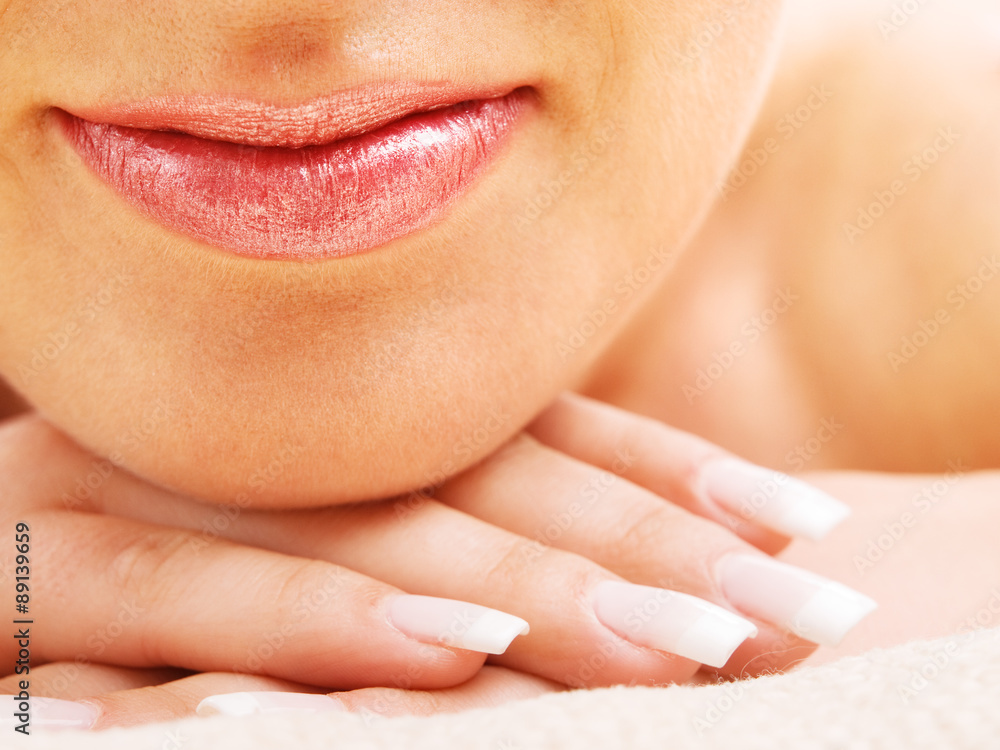 Fototapeta premium Young woman's lips and hand