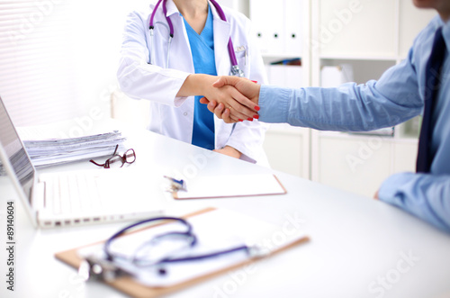 doctor with stethoscope on the patient's admission at the table