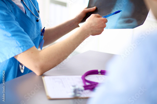 doctor with stethoscope on the patient's admission at the table