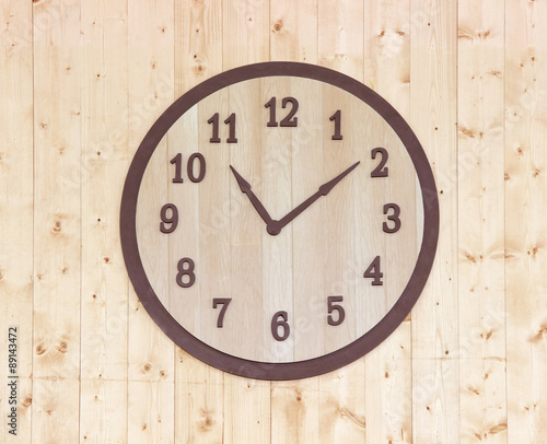 wooden clock on wooden wall background