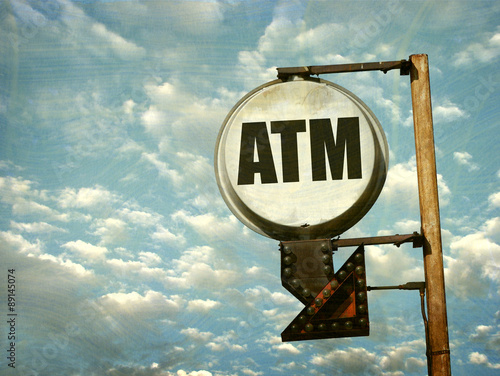 aged and worn vintage photo of atm sign